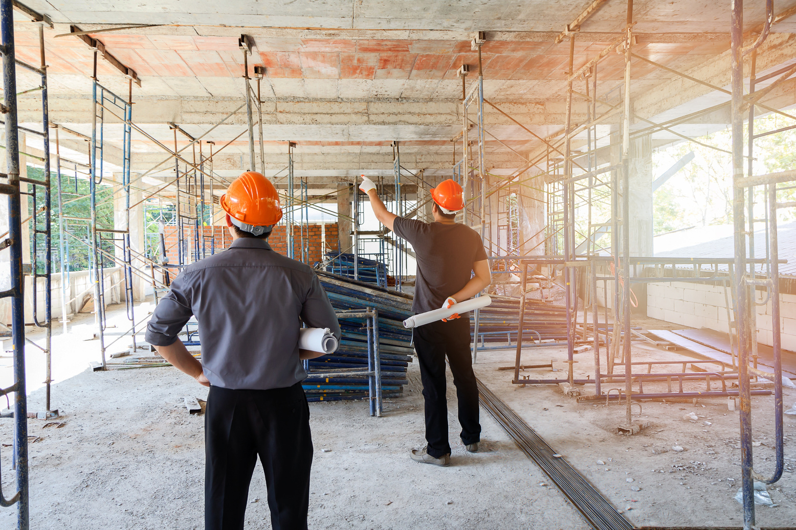 Engineer discussing with foreman about project in building construction site